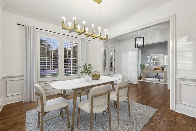 a dining room with furniture potted plants and wooden floor