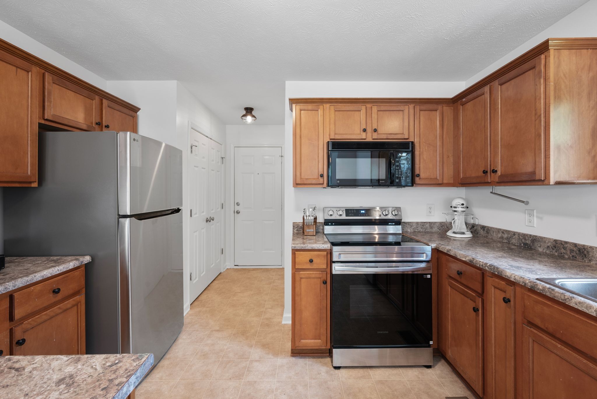4223 Birmingham Road Lebanon, TN 37090 - Photo 11 of 30 a kitchen with stainless steel appliances granite countertop a stove a refrigerator and a stove top oven