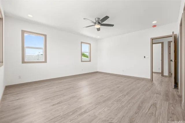 a view of a livingroom with a hardwood floor and a ceiling fan