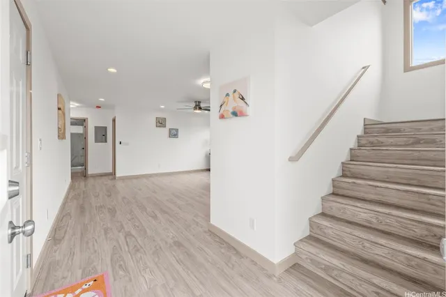 a view of entryway and hall with wooden floor