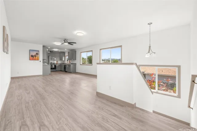 a view of a kitchen with furniture and wooden floor