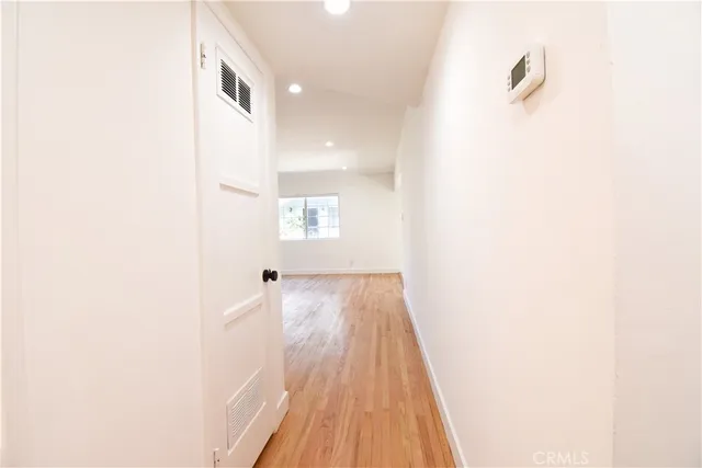 a view of a room with wooden floor and a ceiling fan