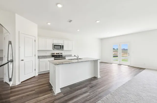 a kitchen with stainless steel appliances a refrigerator and a stove top oven