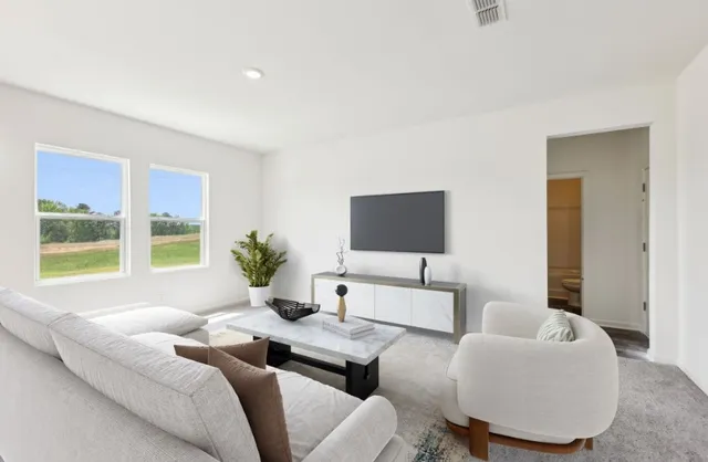 a living room with furniture and a large window
