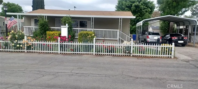 a view of a house with a deck and a large window
