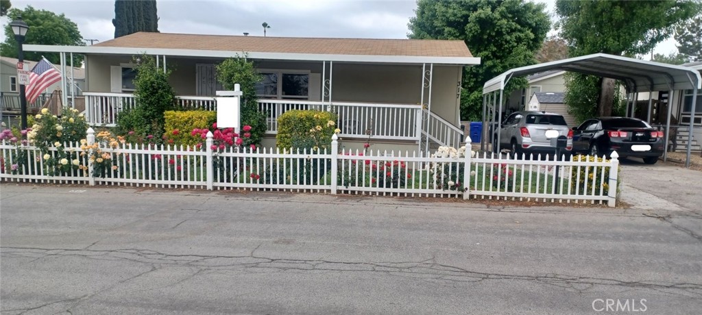 29021 Bouquet Canyon Road, Unit 317 Saugus, CA 91350 - Photo 1 of 24 a view of a house with a deck and a large window