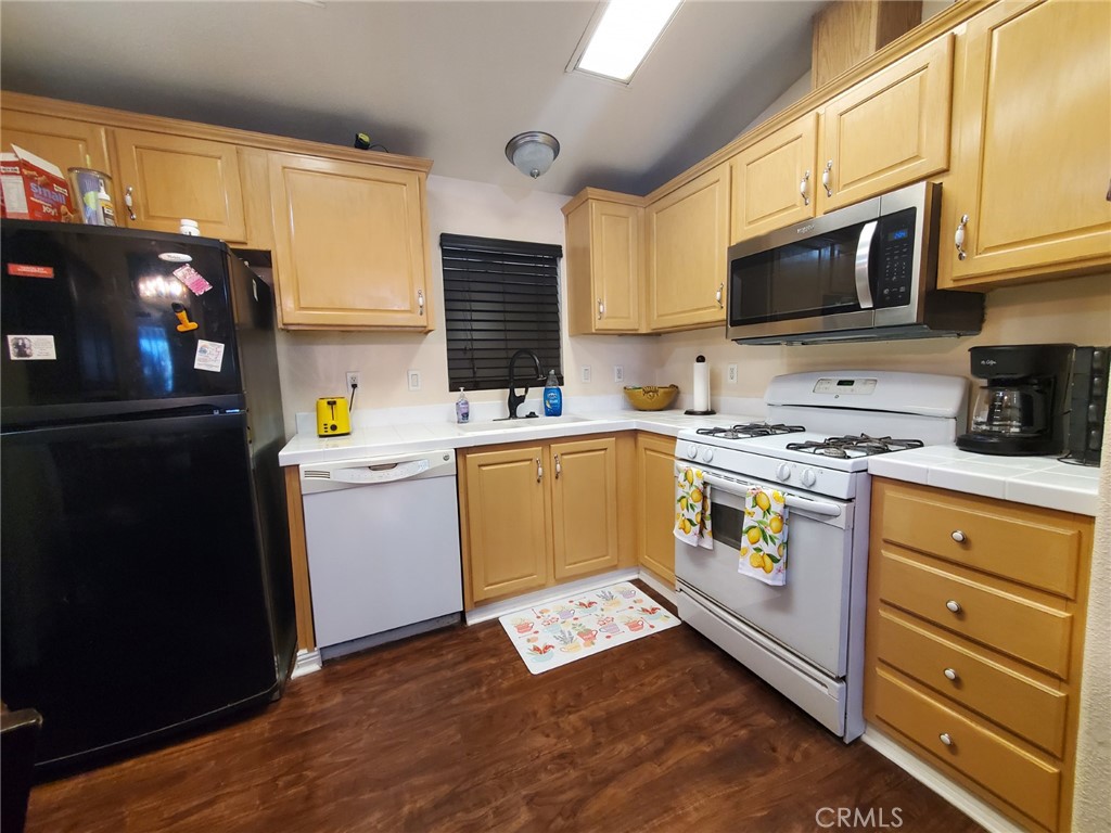 29021 Bouquet Canyon Road, Unit 317 Saugus, CA 91350 - Photo 12 of 24 a kitchen with stainless steel appliances a stove microwave and a refrigerator