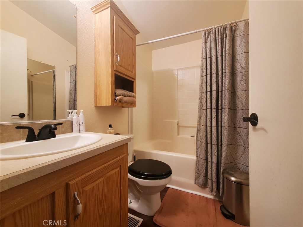 29021 Bouquet Canyon Road, Unit 317 Saugus, CA 91350 - Photo 18 of 24 a bathroom with a sink a toilet and shower