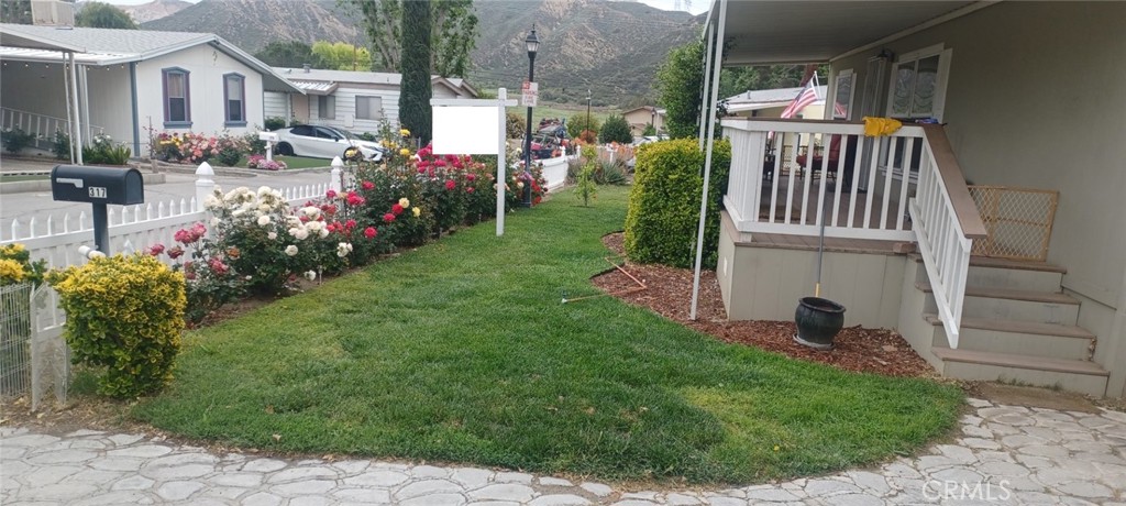 29021 Bouquet Canyon Road, Unit 317 Saugus, CA 91350 - Photo 4 of 24 a view of a house with backyard and sitting area