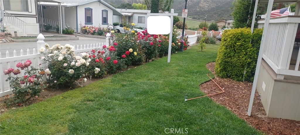 29021 Bouquet Canyon Road, Unit 317 Saugus, CA 91350 - Photo 7 of 24 a front view of a house with a big yard and fountain