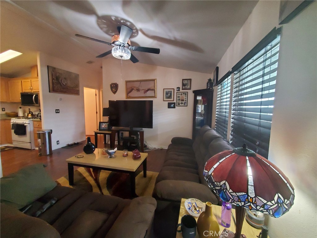29021 Bouquet Canyon Road, Unit 317 Saugus, CA 91350 - Photo 9 of 24 a living room with furniture and a flat screen tv