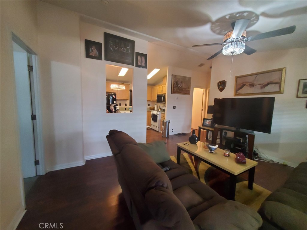 29021 Bouquet Canyon Road, Unit 317 Saugus, CA 91350 - Photo 10 of 24 a living room with furniture a chandelier and a flat screen tv