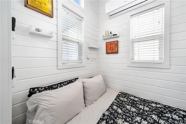 a kitchen with a sink appliances cabinets and a large window