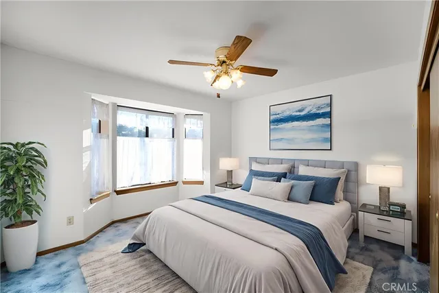 a bedroom with a large bed and a window