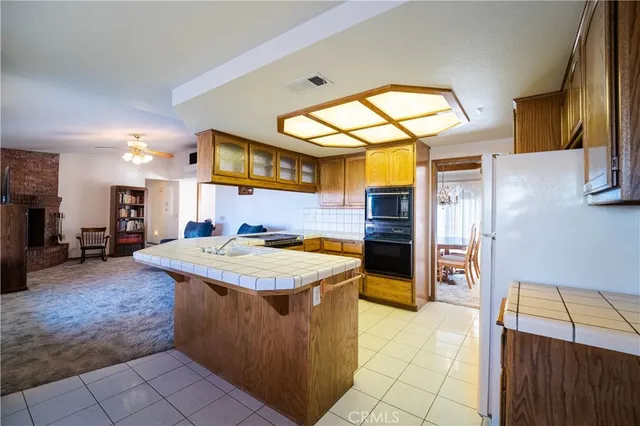 a kitchen with stainless steel appliances granite countertop a sink and a refrigerator