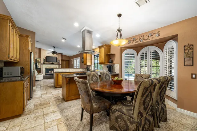 a view of a dining room with furniture and a chandelier