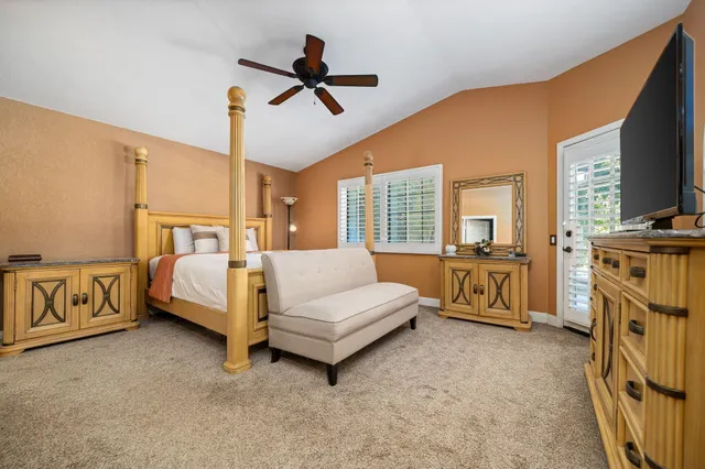 a bedroom with furniture and a flat screen tv