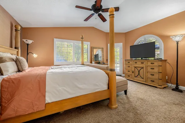 a bed room with a bed and a tv