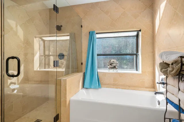 a bathroom with a tub and a shower