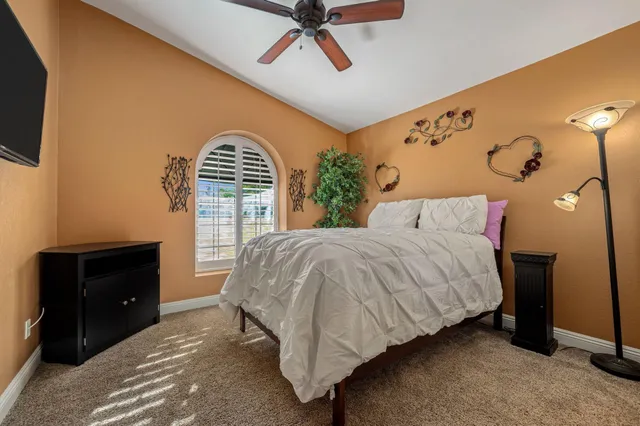 a bedroom with a bed and a television