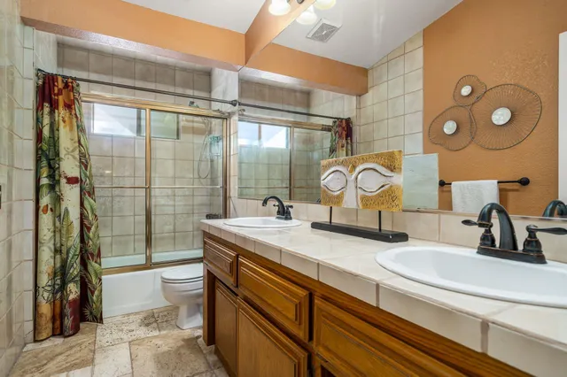 a bathroom with a sink double vanity and a shower