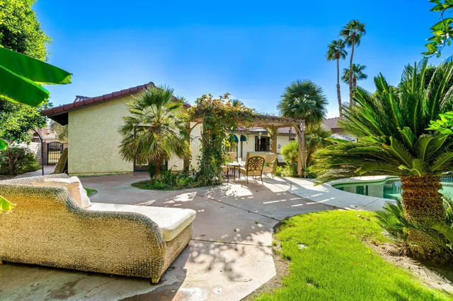 a view of a backyard with swimming pool
