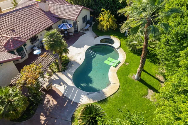 a view of a swimming pool with sitting area