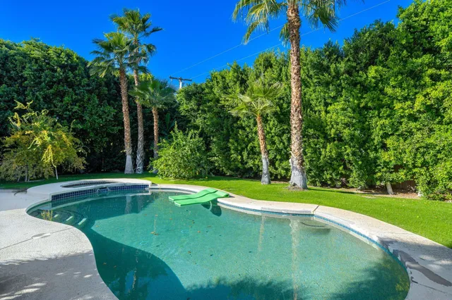 a view of a swimming pool with a yard