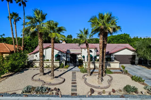 an aerial view of a house with outdoor seating