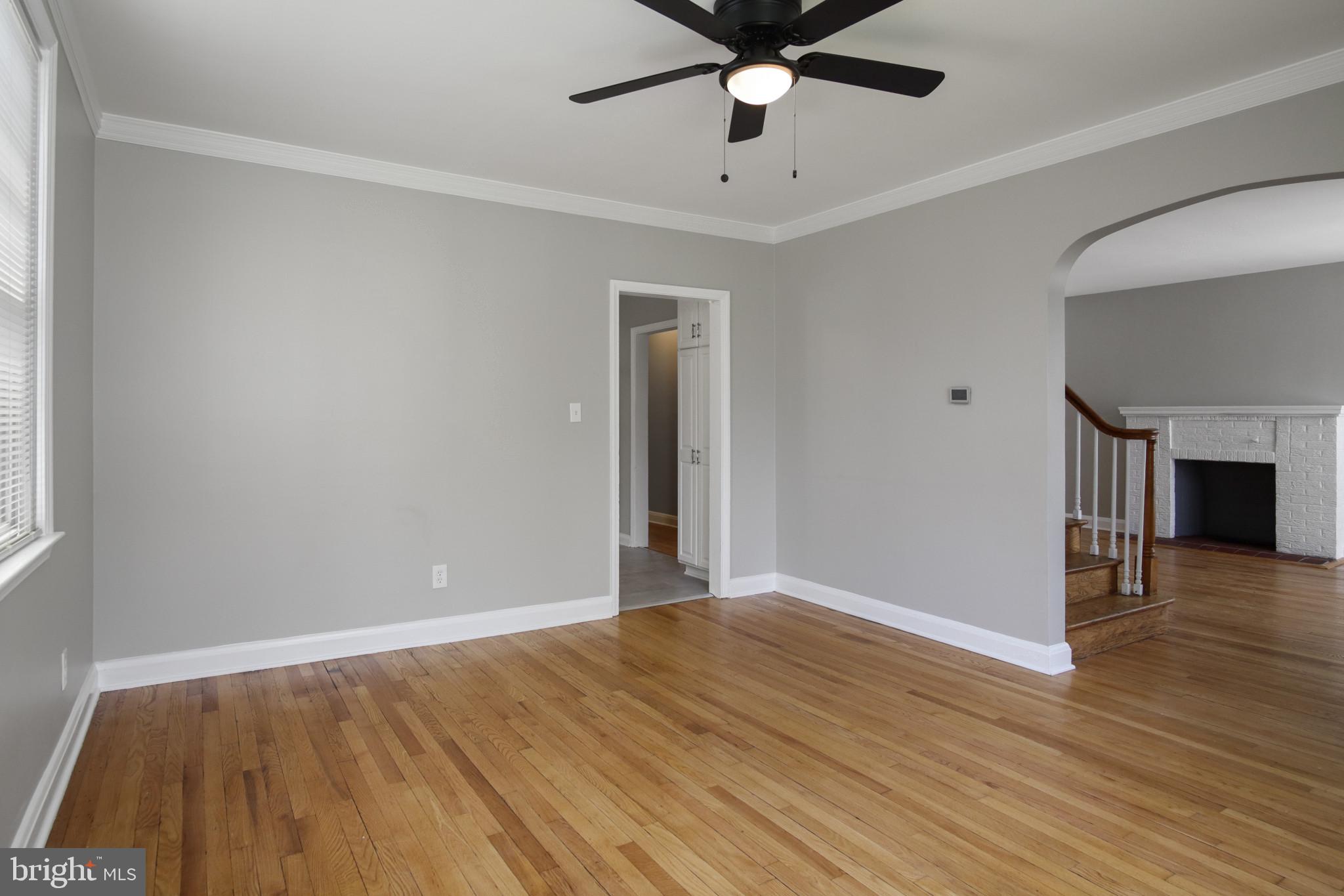 608 Farmhurst Road Baltimore, MD 21208 - Photo 12 of 45 an empty room with wooden floor and windows