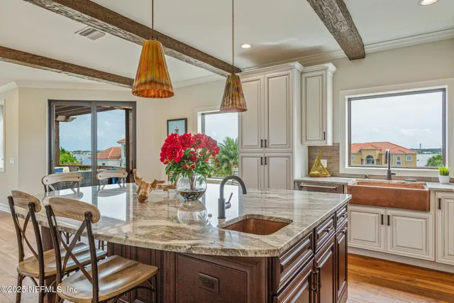 a dining room with furniture a chandelier and wooden floor