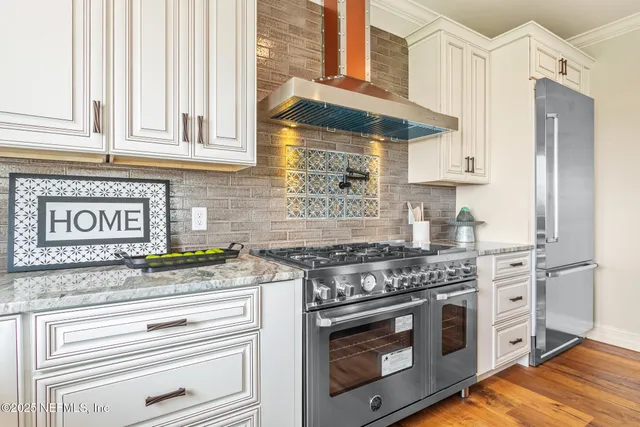 a view of a hallway with wooden floor and windows
