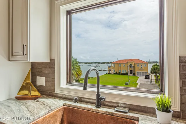 a living room with furniture floor to ceiling window and wooden floor