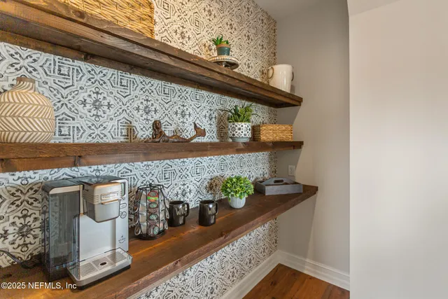 a view of a chairs and table in patio with a balcony