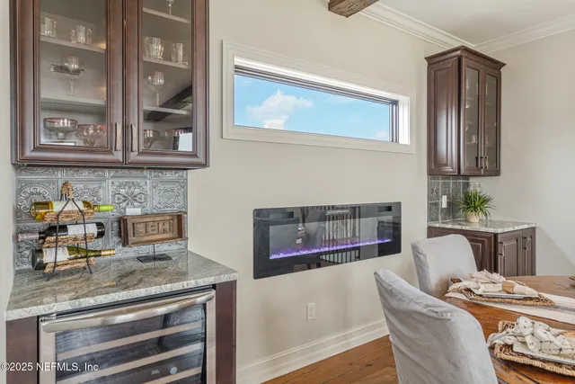 a front view of a house with a garden and palm trees