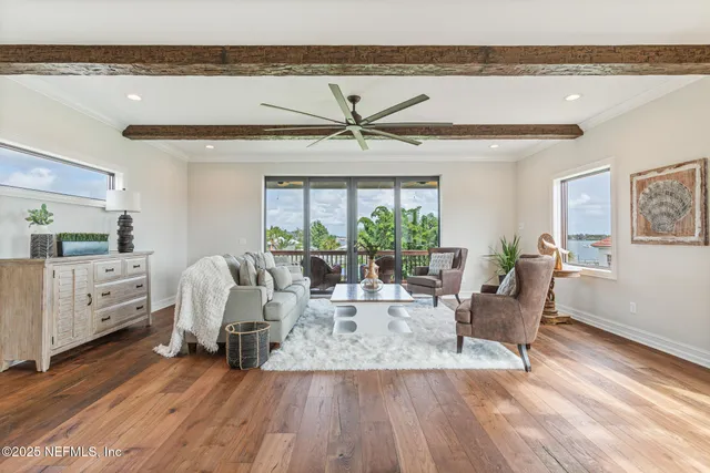 a view of hallway with chandelier and wooden floor