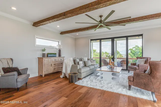 a view of a hallway with wooden floor and cabinet