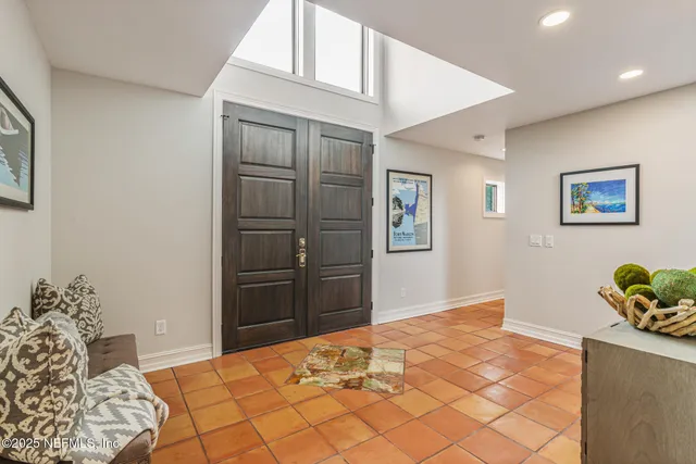 a dining room with furniture and flower plants