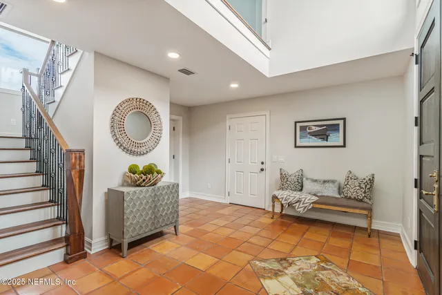 a kitchen with stainless steel appliances granite countertop white cabinets and a stove top oven