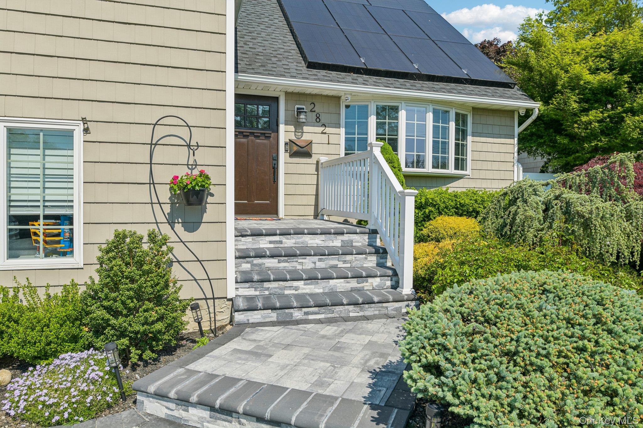 2821 Colonial Avenue Merrick, NY 11566 - Photo 2 of 29 front view of a house with potted plants