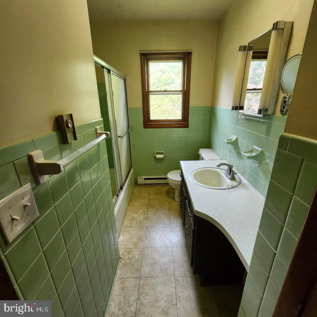 2445 Bear Wallow Hollow Road Augusta, WV 26704 - Photo 12 of 22 a bathroom with sink and mirror