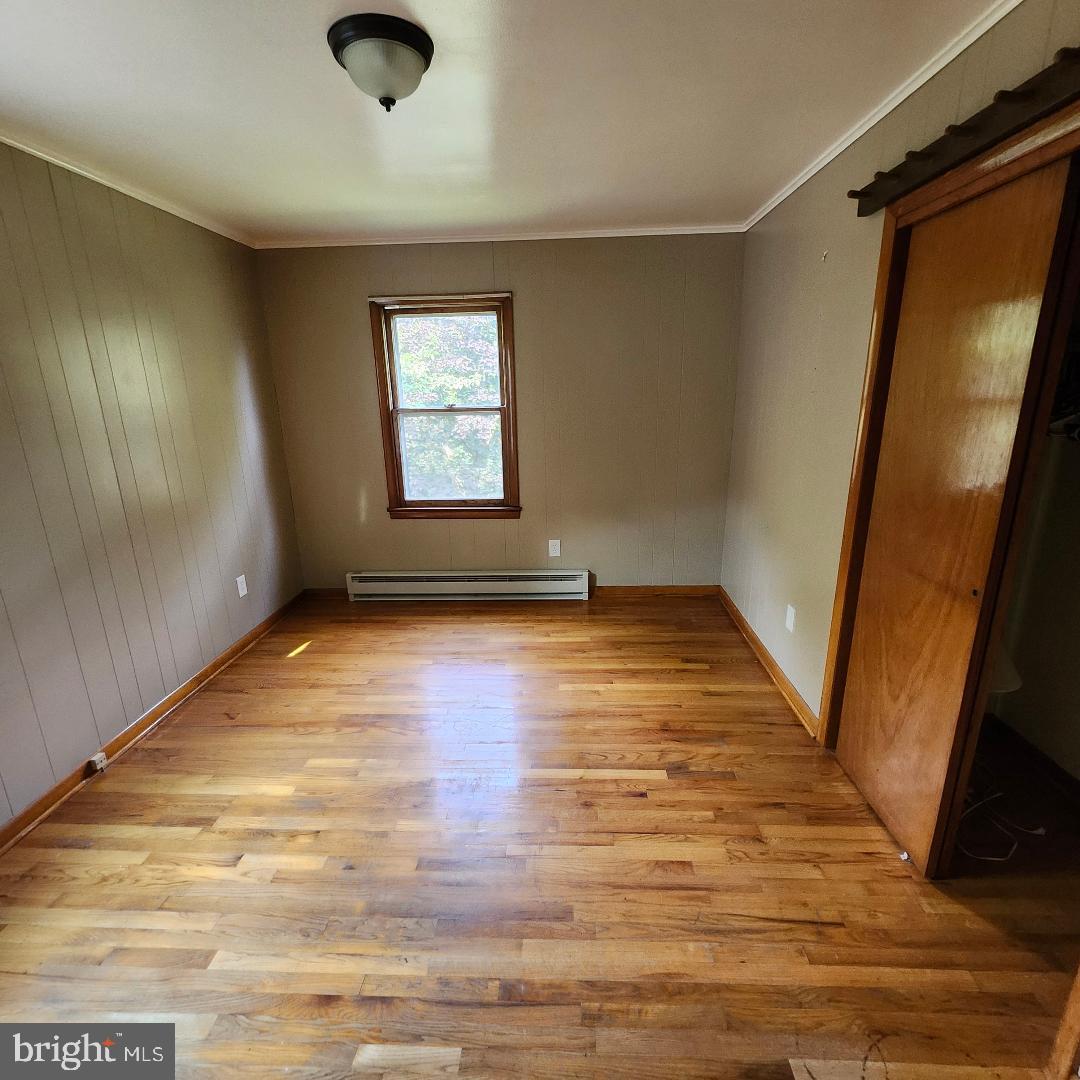 2445 Bear Wallow Hollow Road Augusta, WV 26704 - Photo 8 of 22 an empty room with wooden floor and windows