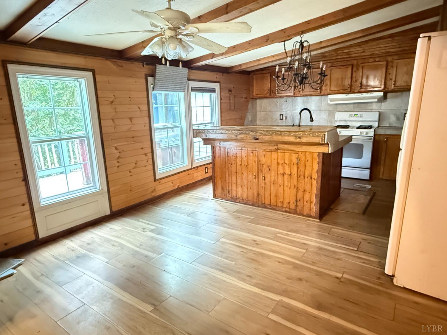 3974 Germantown Road Keysville, VA 23947 - Photo 2 of 42 a kitchen with stainless steel appliances granite countertop a sink a stove a washer and dryer with wooden floor