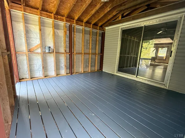 an empty room with wooden floor and door