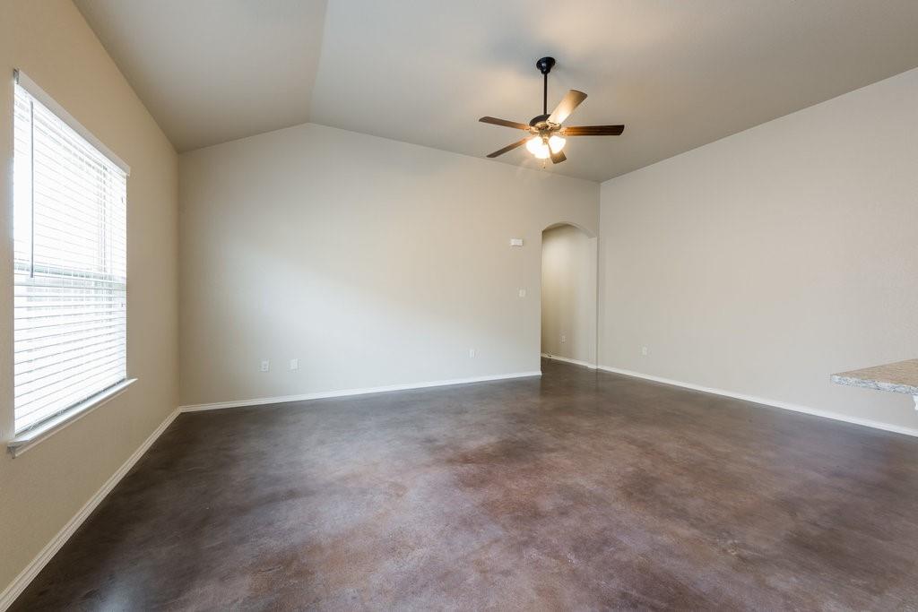 491 Jack Rabbit Lane, Unit A Buda, TX 78610 - Photo 9 of 22 Vast open floor space, vaulted ceiling, and rich brown floors characterize this inviting living room.