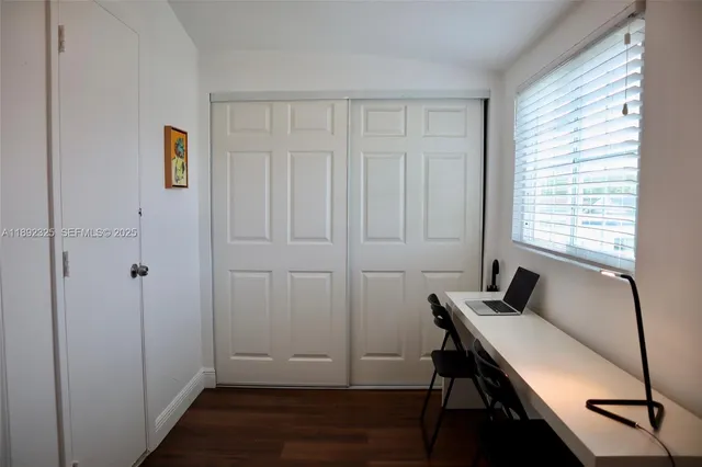 a room that has a window and wooden floor
