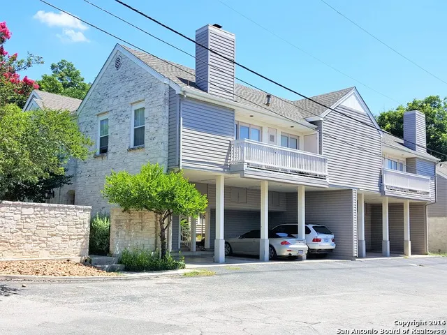 a view of a house with small yard and plants