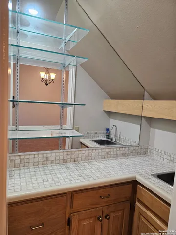 a kitchen with a sink and a refrigerator