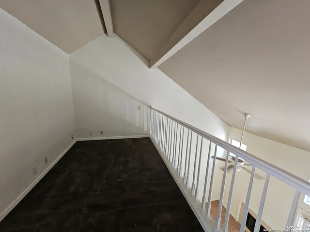 a view of a hallway with stairs