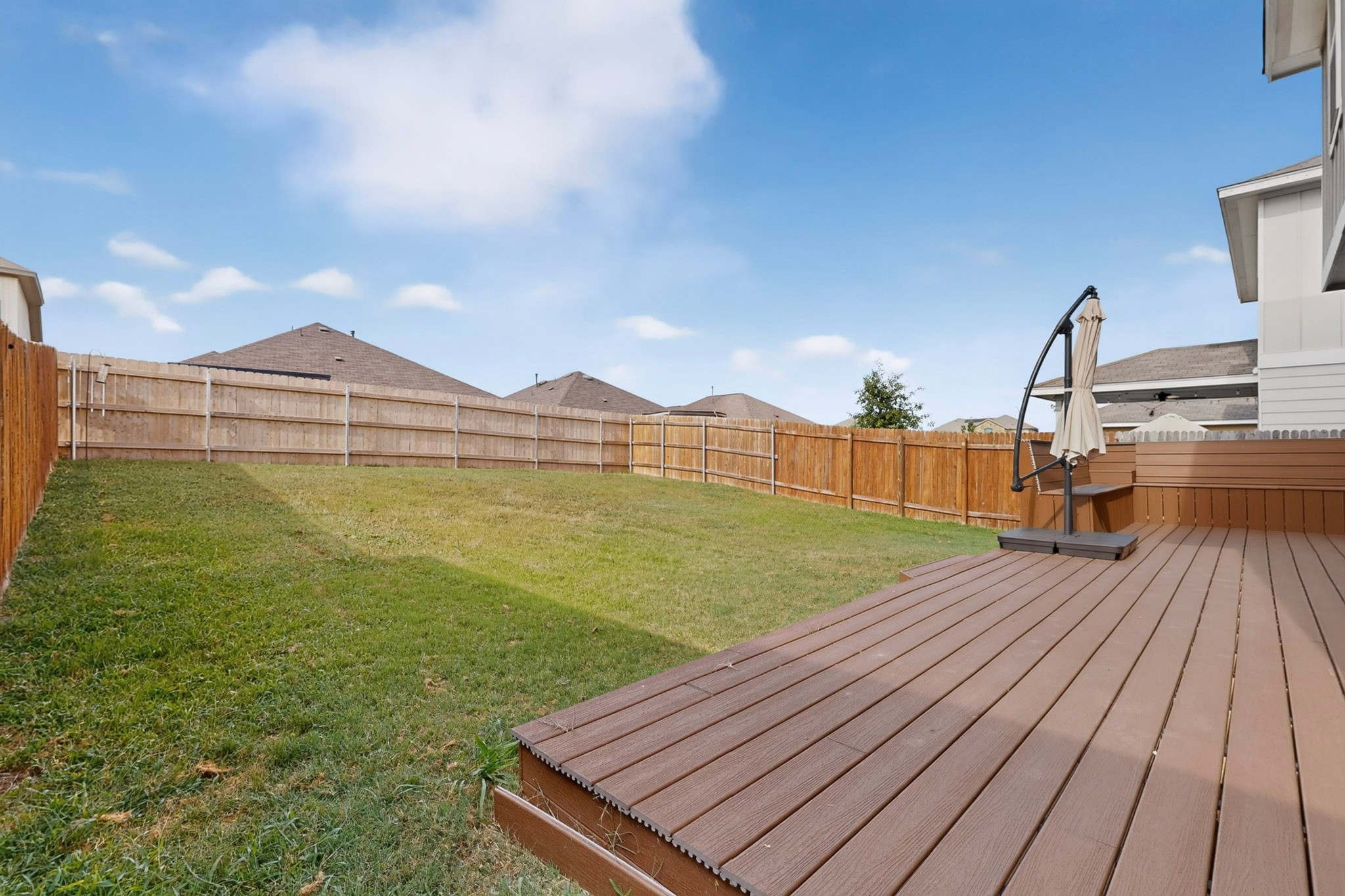132 Wapiti Road Buda, TX 78610 - Photo 24 of 31 A spacious backyard with a private wooden fence provides ample space for relaxation and recreation.